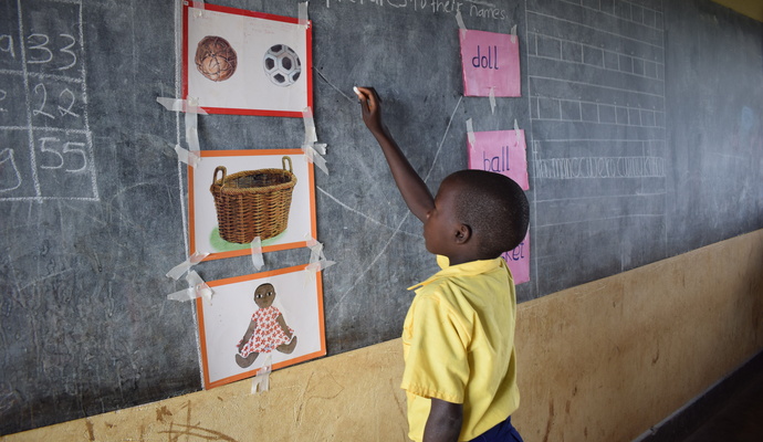 Gutt skriver på Tavle i Uganda